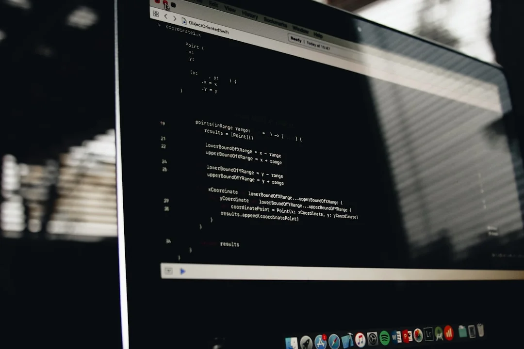 Two monitors on a desk, displaying web design in a modern office environment.